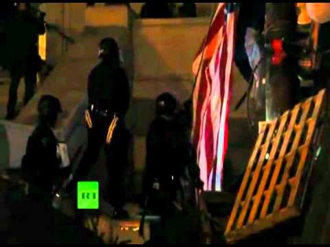 LAPD desecrates American flag at Occupy LA - Cop rips the American flag