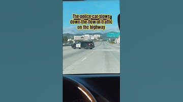 The police car slows down the flow of traffic on the highway. Inst.: arasks