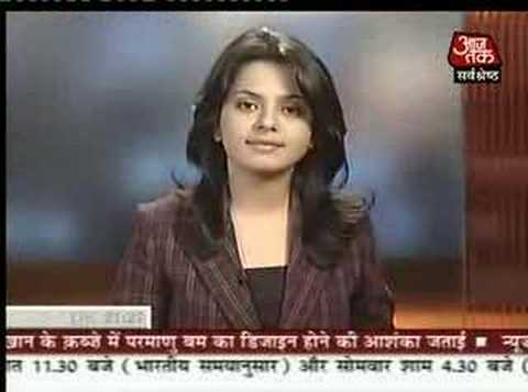 News presenter starts to brush her hair during the news segment.
