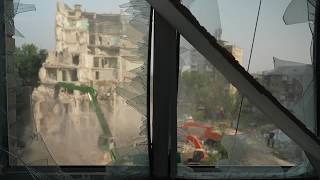 Survivors retrieve belongings from homes after Russian strike