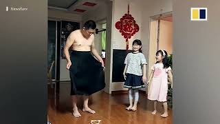 Chinese father puts on dress to show daughters ‘proper way’ to behave