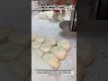 Using A Handheld Metal Tool To Flatten Uniform Circles Of Dough