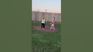 Girls playing tether ball before the drive-in movie