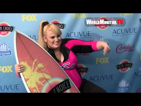 Rebel Wilson Hilarious arriving at 2013 Teen Choice Awards press room with Surfboard