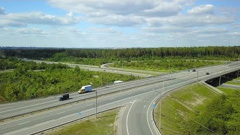 Aerial Shot Road with Transport Interchange on the Background of Green Forest | Stock Footage -