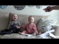 Baby laughing hysterically at ripping paper with little sister