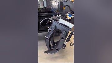 Backhoe loader with log grapple