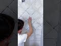 filling white cement in the gaps between the ceramic tiles is done by skilled workers