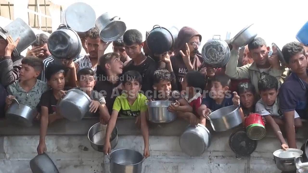 Desperate crowd of adults and children seek portion of some of the last food aid left in Gaza: rice