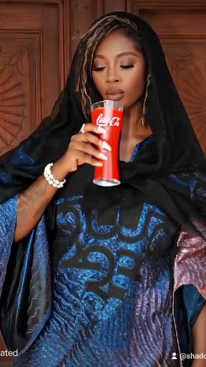 tiwa Savage drinking Coke