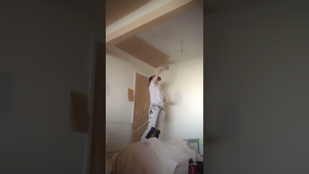 Spraying a mist coat on bare plaster