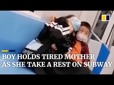 Boy holds tired mother so she can take a rest on subway in China