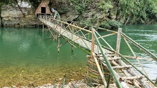 The man built a bridge across the stream to enter the house on the cliff