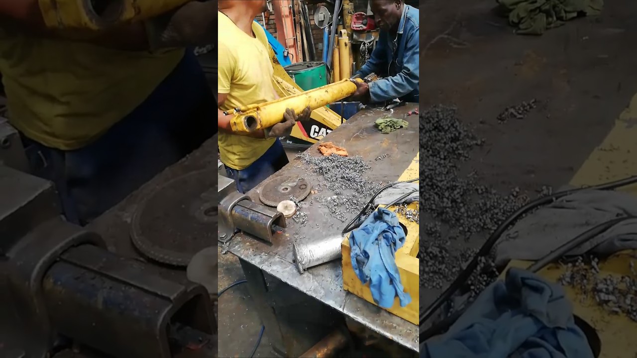 HOLDING IN VICE TO PULL OUT BENT ROD FROM BARREL IN FIXING DAMAGED PISTON AFTER CATERPILLAR OVERLOAD