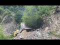 Very perfect work by bulldozer komatsu against rocks trees and so on