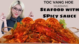 Vietnamese girl eats giant seafood tray with spicy sauce