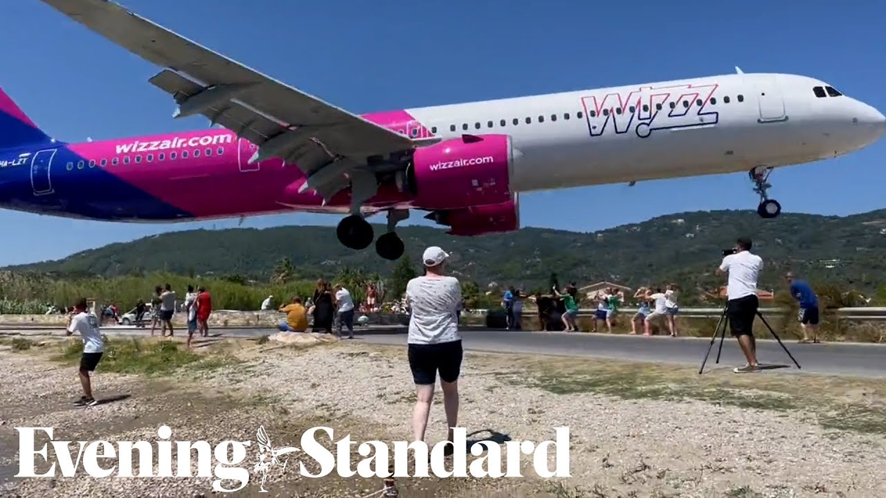 Terrifying moment a Wizz Air plane flies just metres above tourists’ heads at Greek airport