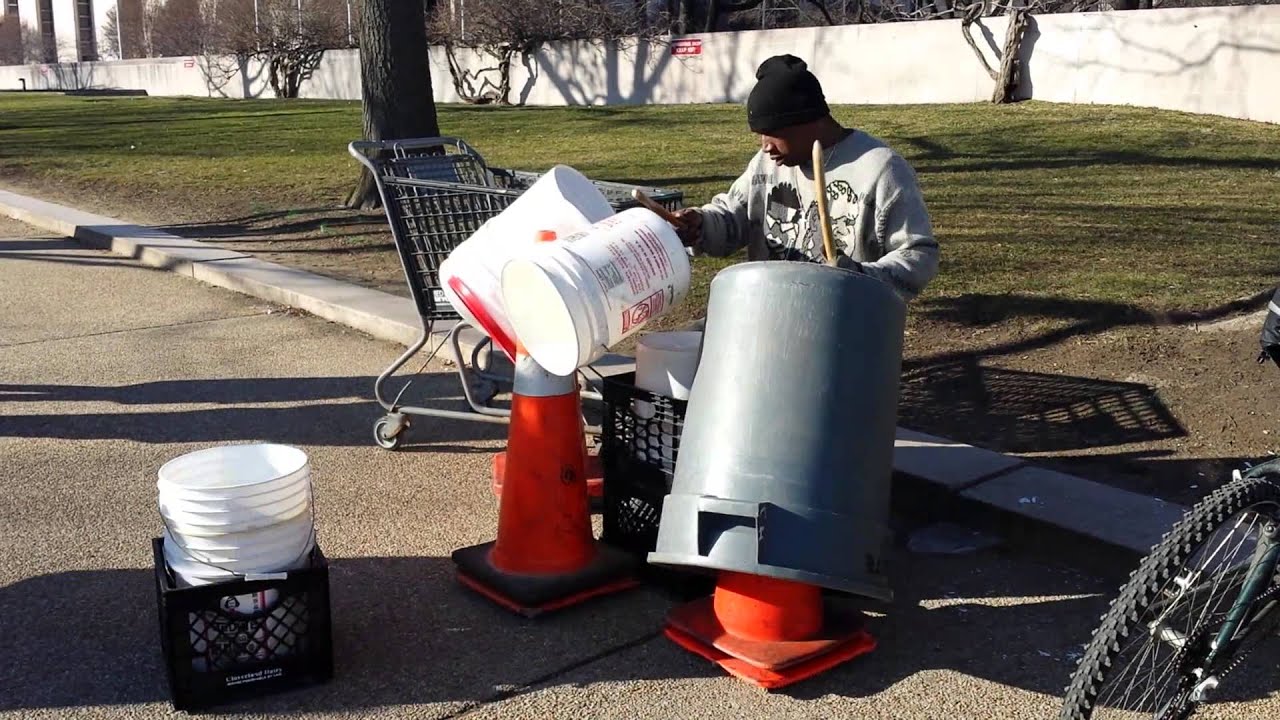 Street drummer playing on buckets YouTube