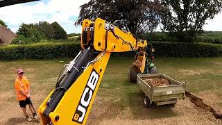 Backhoe works on new drainage for a sports field