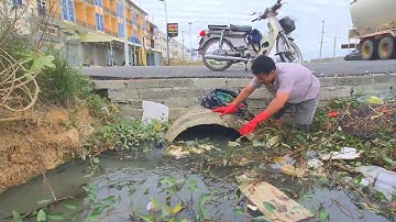 Hard Work Try to Remove Plastic and Garbage clogged culvert pipe avoid Water Pollution