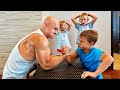 Little hulk arm wrestling a bodybuilder in the gym