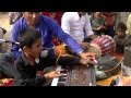child singing Christian bhajan and playing harmonium in Indian village