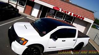 Nissan Titan with Window Tinting, smoked tail lights and custom wrap.