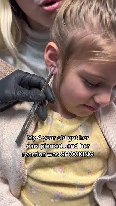 SHOCKING reaction to getting her ears pierced.. #shorts