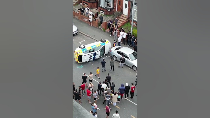 CHAOS erupted on a residential street in Leeds as an angry mob overturned cop car