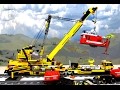 Big Lego train crane lifting locomotive after a heavy storm