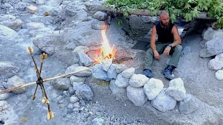 Primitive shelter in the Alps - bushcraft water wheel - slow cooked giant trout
