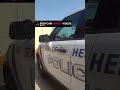 Cop tries to comfort suspect before the booking