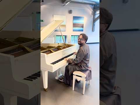 A White Piano Between Light and Horizon