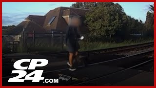 Video shows pedestrian desperately pulling dog in series of near misses on U.K. rail crossing