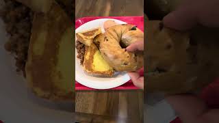 Raisin bagel, French toast, corn beef, potatoes, sausage links, hard boiled egg and coffee no sugar.