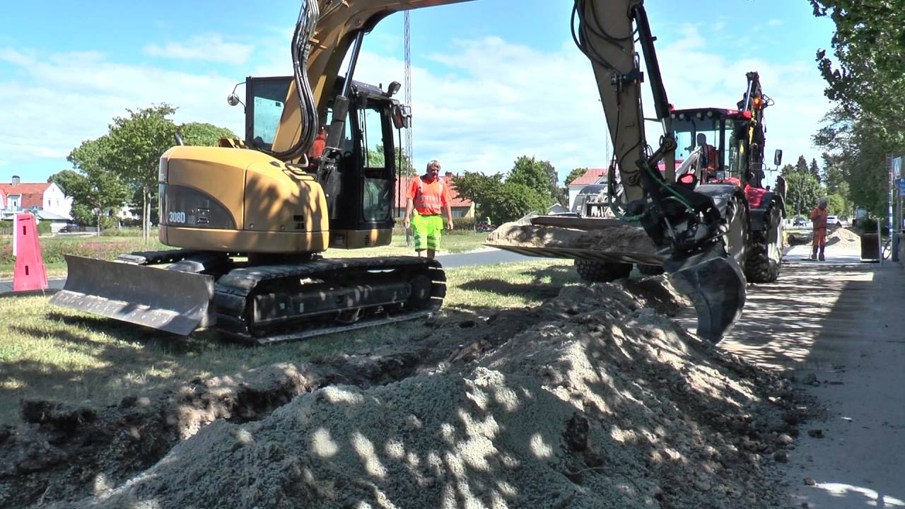 Huddig 1260 and a Cat 308 D at a trench to fill with sand and soil in June 2016