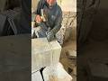 Splitting stone block with hammer and chisel creating clean precise edges smooth