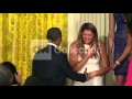 OBAMA TRIES TO HELP WOMAN FALLING OFF STAGE