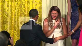 OBAMA TRIES TO HELP WOMAN FALLING OFF STAGE