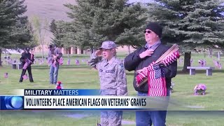 Volunteers place flags at Montana State Veterans Cemetery