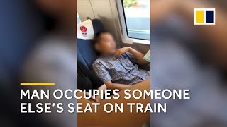 Man occupies someone else’s seat on train in China