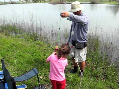 4-year-old catching a fish with her Dora fishing pole. 