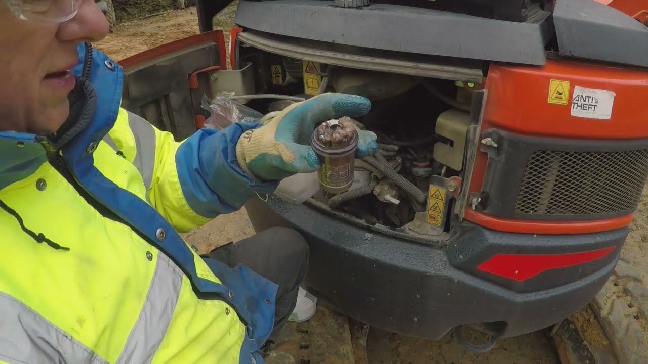 servicing Kubota U27 4 water trap on fuel line