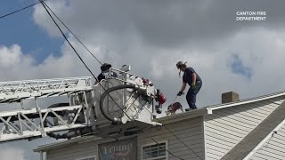 WATCH: 'Lucky' dog trapped on 'woof' of house rescued by Canton firefighters