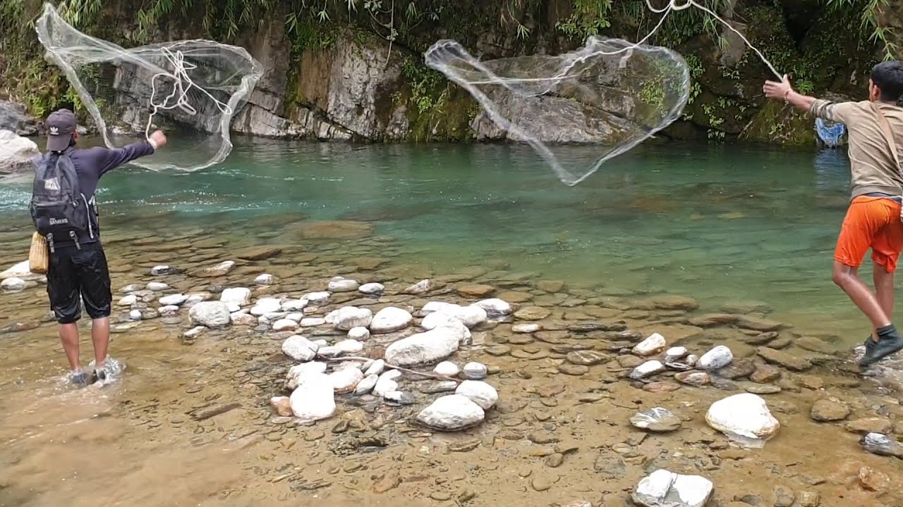 HIMALAYAN TROUT FISHING IN SMALL STREAMY RIVER OF NEPAL