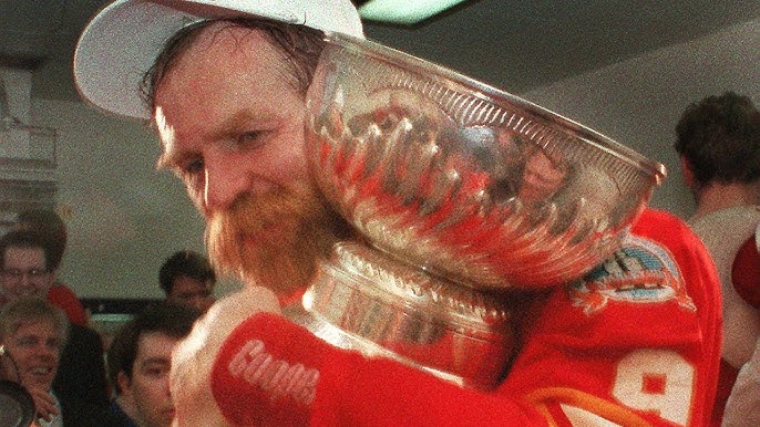 Playing for The NHL Greats Lanny McDonald (R) a retired Calgary Flames  player chats with a linesman during the JUNO Cup Hockey game at the  Stampede Corral in Calgary, Alberta, April 4