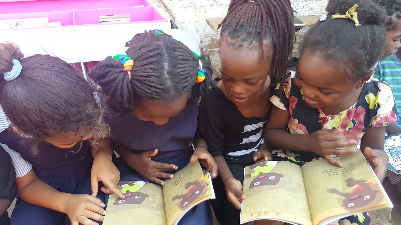 Girls excited by their first ever reading books! - Malawi - The CharChar Trust