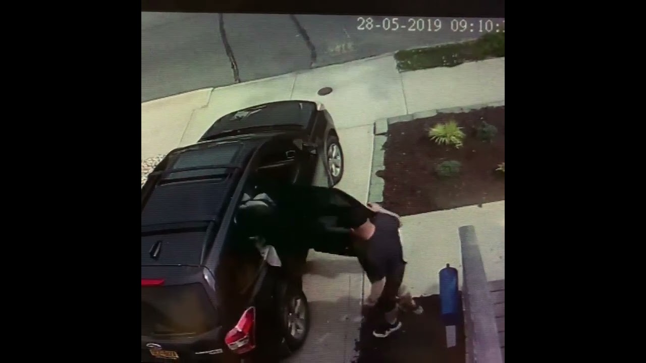 Guy opens car door and little boy accidentally walks into it Security camera