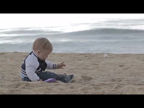 Boy Playing With Beach Sand Stock Video