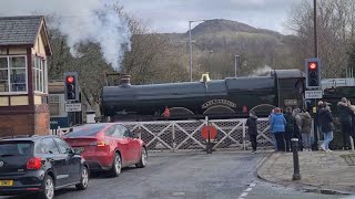 Cars wait as 'new' steam locomotive crosses main road in busy town